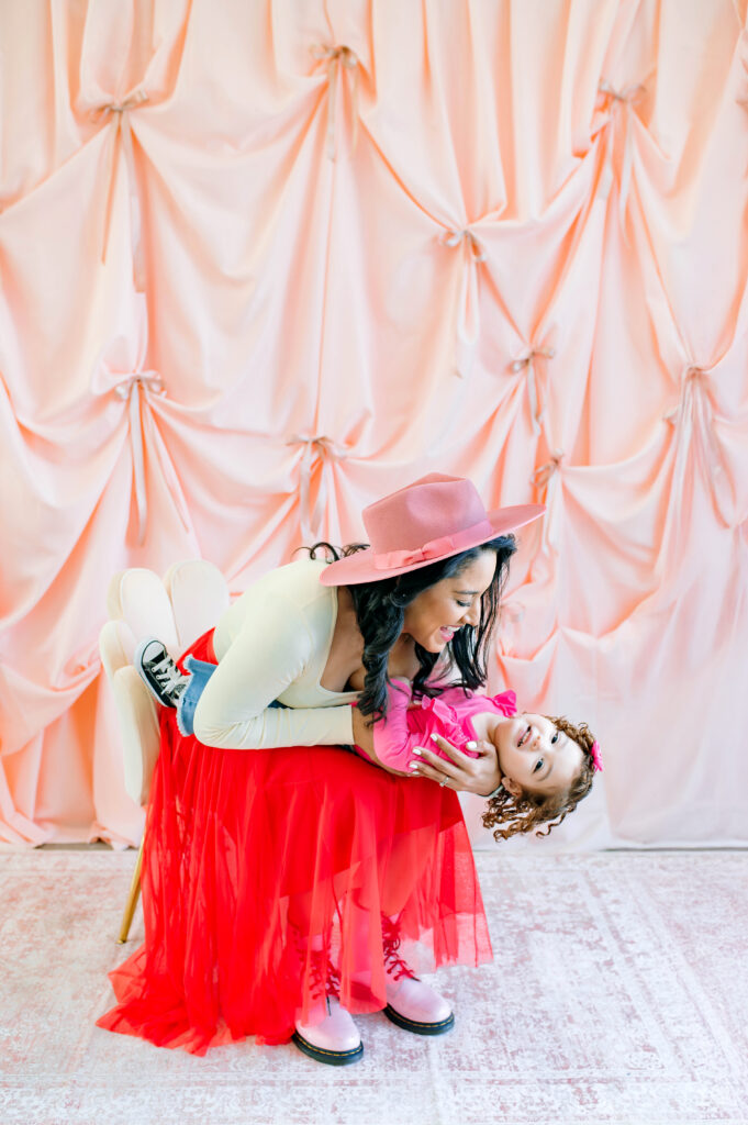 Mommy and me Valentine’s Mini Session in McKinney Texas with pink fabric backdrop and red tulle skirt