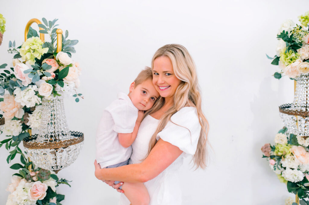 Mom holding her son while looking at the camera during a portrait session with Jennifer L Kirk Photography in Mckinney, Texas. 